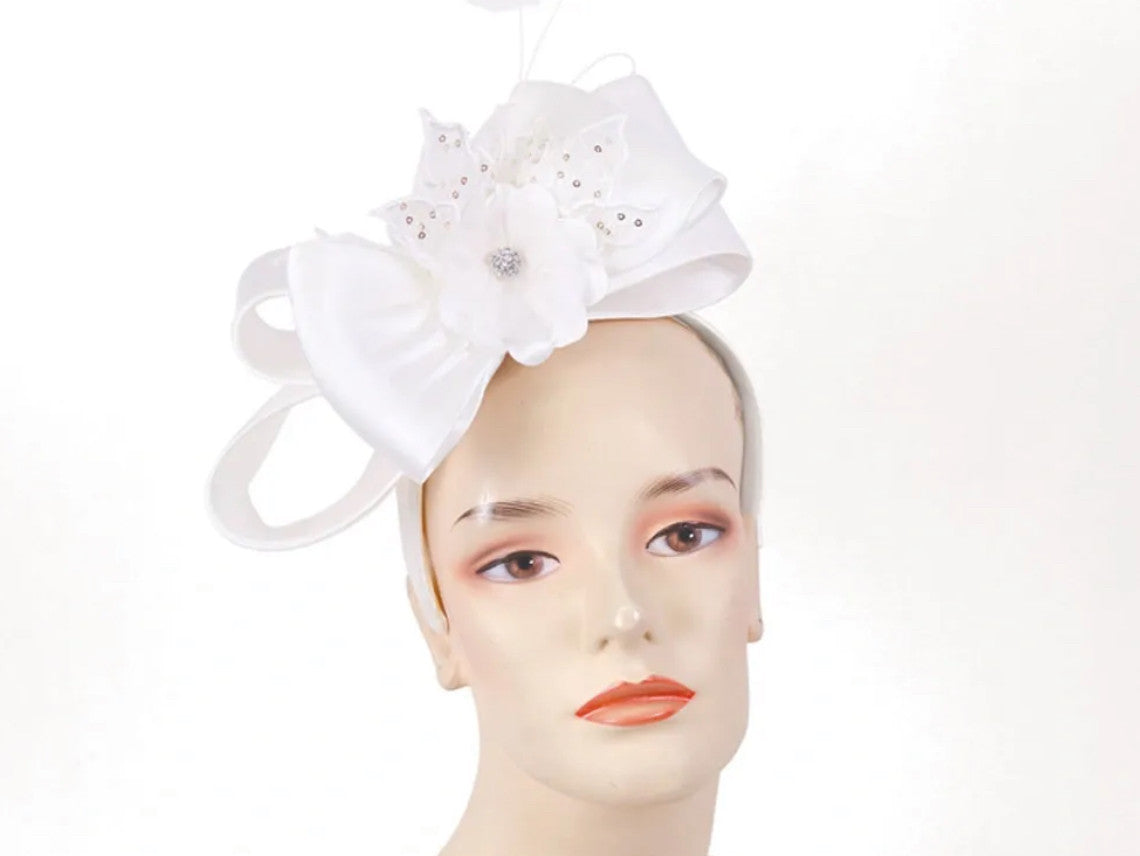 This bow beauty fascinator is accented by a flower and rhinestones.